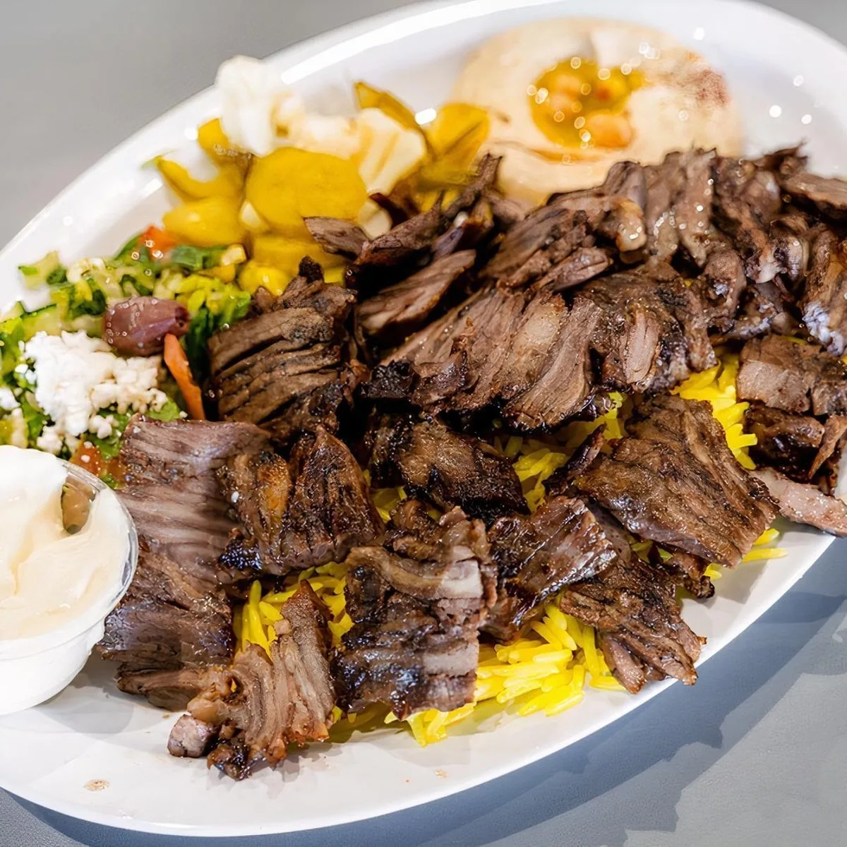 kilo Chawarma 01 "كيلو من شاورما اللحم الشهي، مُعدّة بتوابل مميزة وتقدم مع صوصات لذيذة."